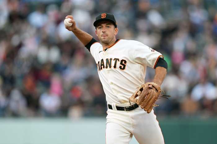 SF Giants infielder Jason Vosler throws a ball to first base.